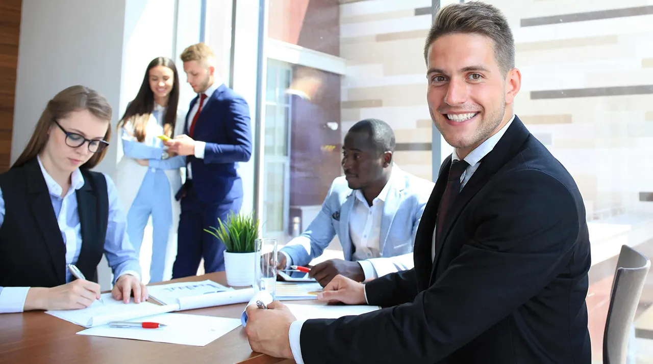 Group of employees working at a conference table